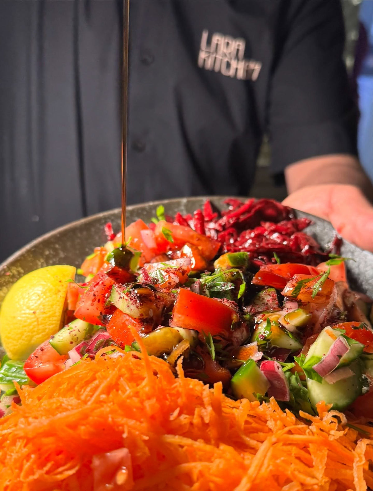 Fresh salad with pomegranate dressing at LARA KITCHEN